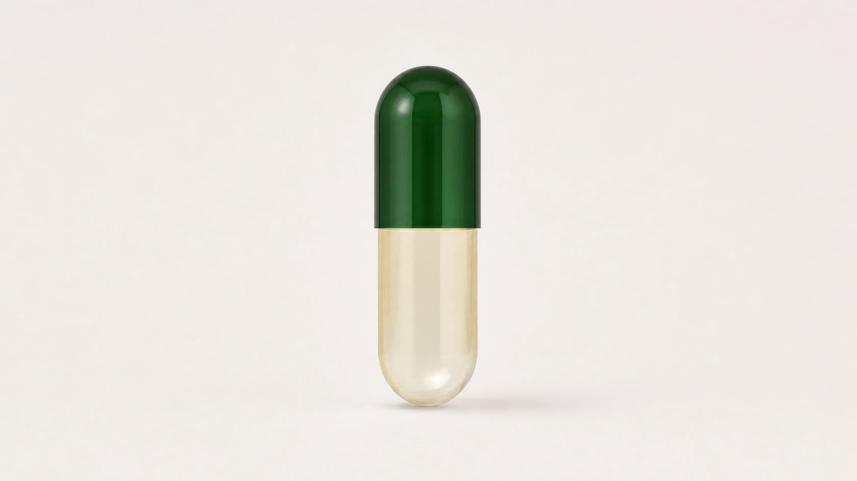 Upright empty size 00 HPMC capsule with a green cap and translucent white body