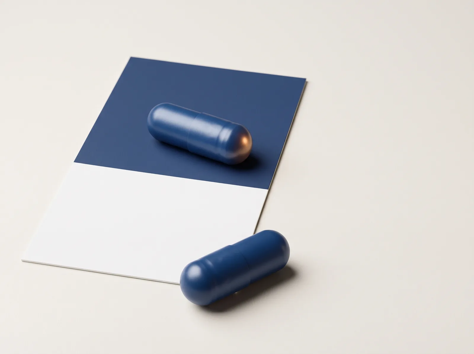 Two blue capsules beside a blue and white colour card.