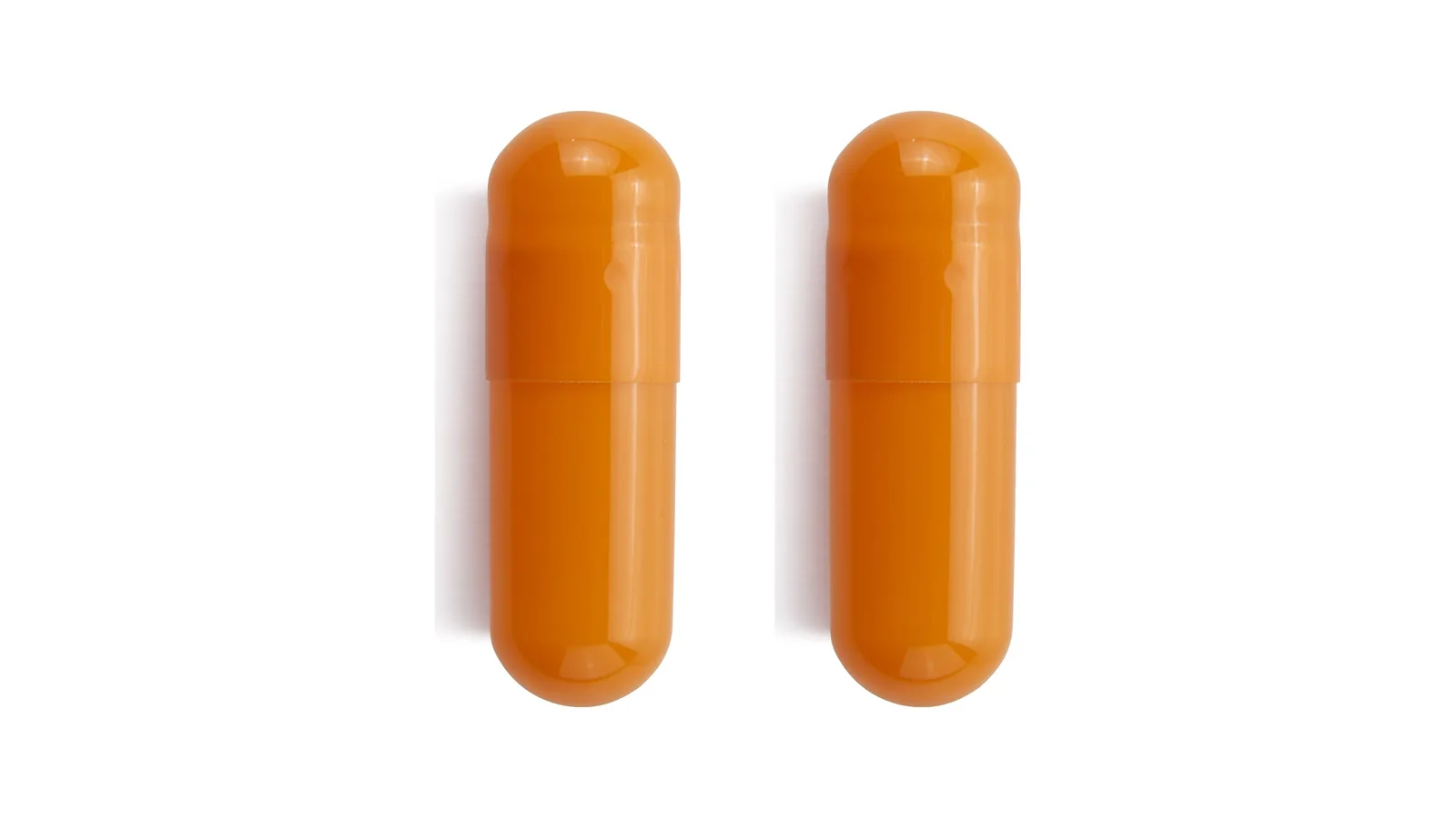 Two similar orange capsules side by side on a white background.