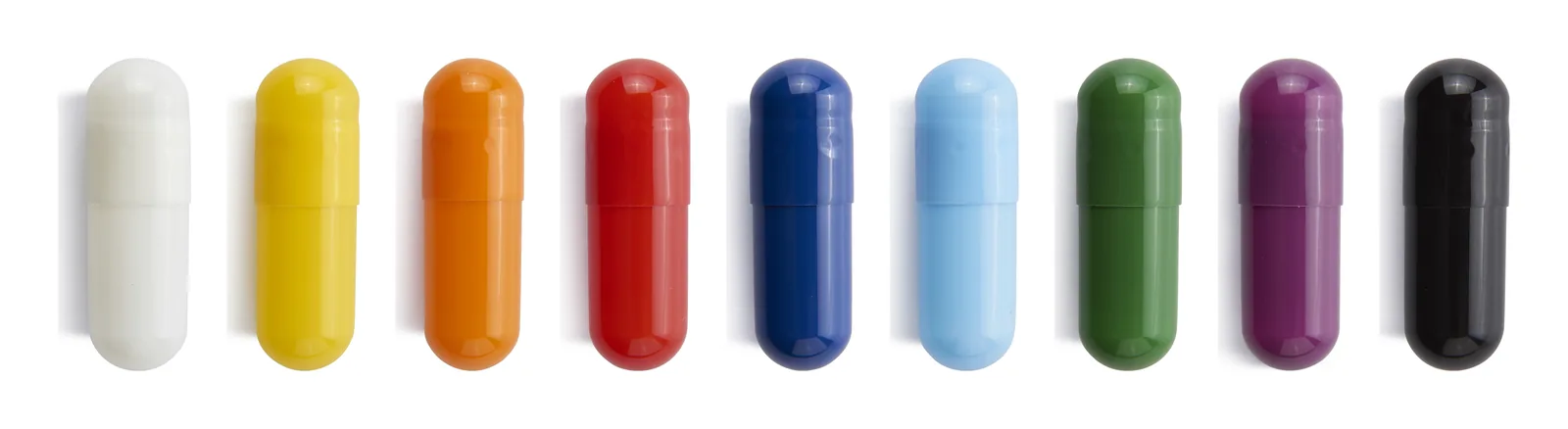 Nine photographed opaque capsules in white, yellow, orange, red, dark blue, light blue, green, purple and black.